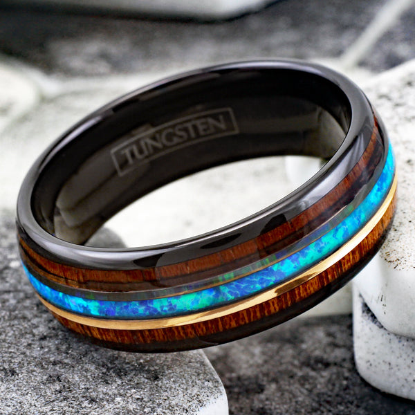 Gorgeous Polished Black Tungsten Low Dome Ring with Iridescent Man-Made Crushed Hawaii Blue Opal Inlay Between Two Rose  Surrounded By Koa Wood Inlays.