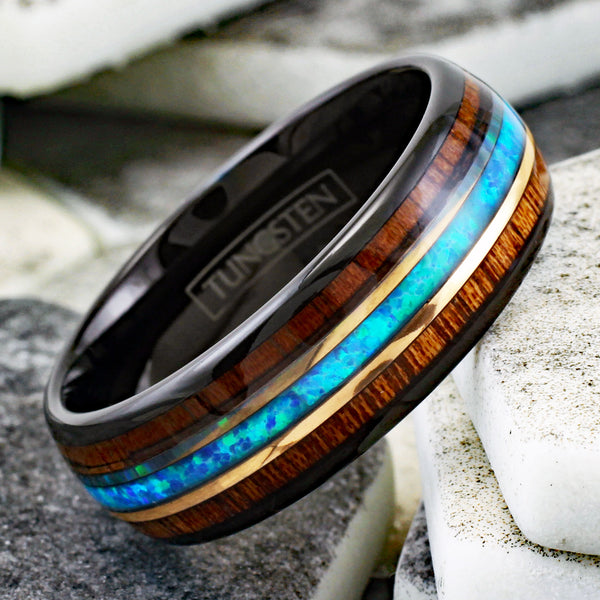 Gorgeous Polished Black Tungsten Low Dome Ring with Iridescent Man-Made Crushed Hawaii Blue Opal Inlay Between Two Rose  Surrounded By Koa Wood Inlays.