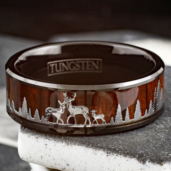 Beautiful Polished Finish Black Flat Band Tungsten Ring With Silver Deer Family In Forest Scene Overlay On Wood Inlay.