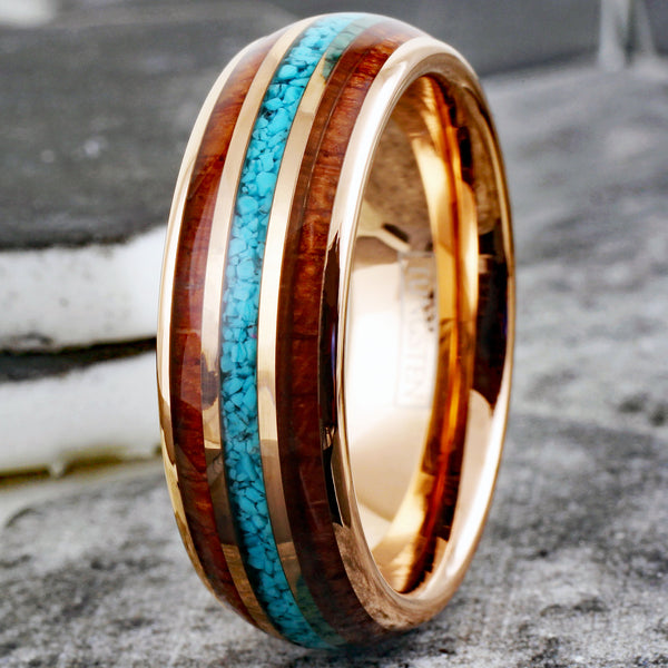 Gleaming Polished Rose Gold Low Dome Tungsten Ring with Crushed Blue Turquoise Inlay Between Koa Wood Inlays.