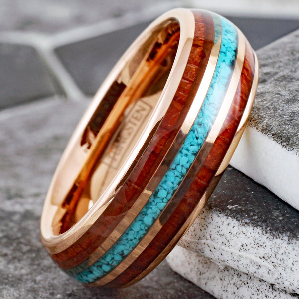 Gleaming Polished Rose Gold Low Dome Tungsten Ring with Crushed Blue Turquoise Inlay Between Koa Wood Inlays.