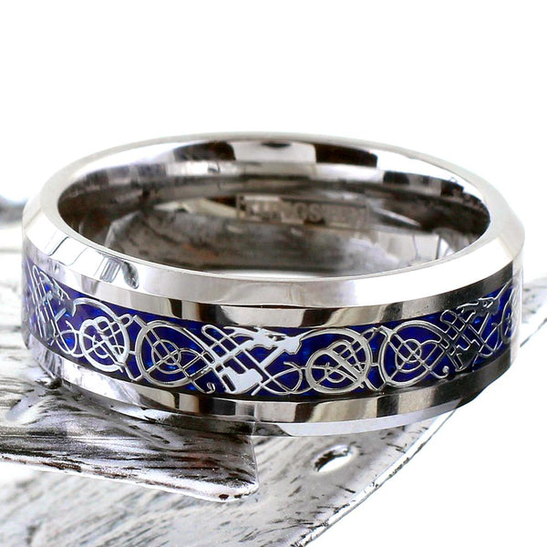 Polished silver tungsten carbide ring w/ silver Celtic dragon on sapphire blue faux carbon fiber inlay | Flat leaf Photo