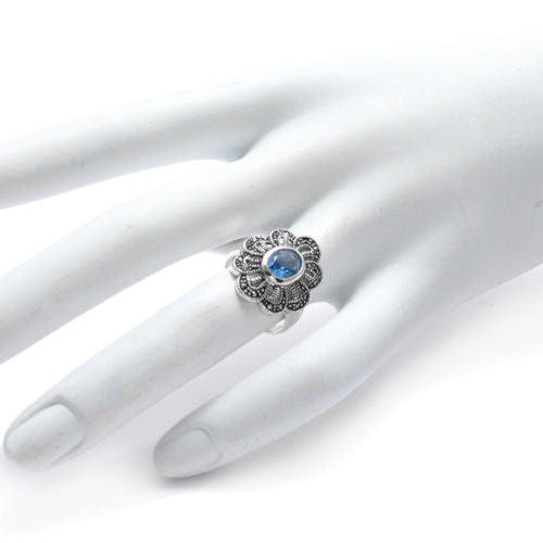 Marcasite flower ring with light blue CZ. Wholesale sterling silver rings. Hand photo.