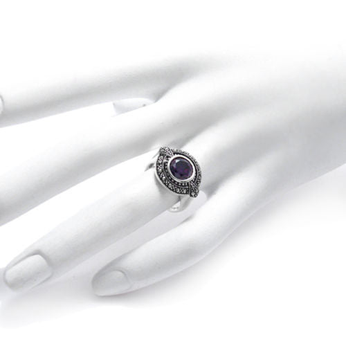 Classic oval marcasite ring with 1.75 carat purple CZ. Wholesale Sterling Silver Rings. Hand photo.