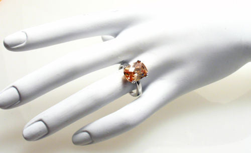Sterling ring with 10x14mm rectangular champagne colored CZ solitaire. Wholesale sterling silver rings. Hand photo.